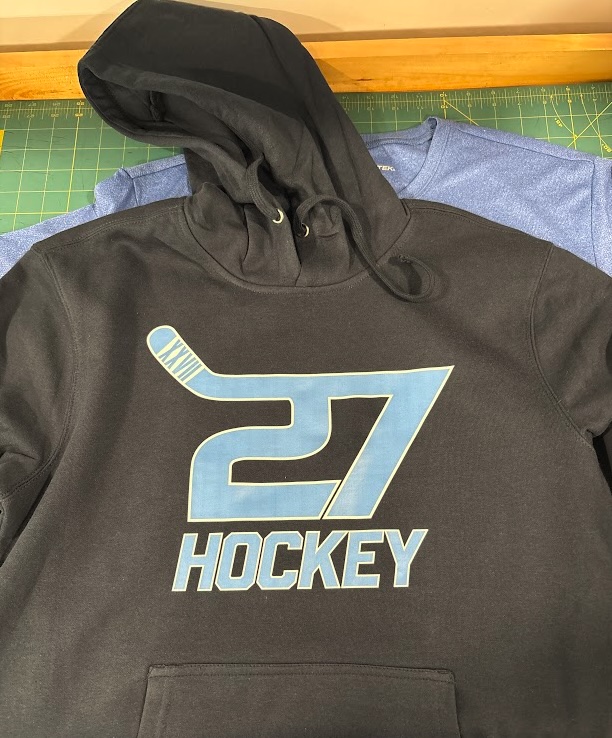 Custom black youth hockey hoodie with blue and white number 27 hockey graphic for a New Jersey travel or school hockey team.
